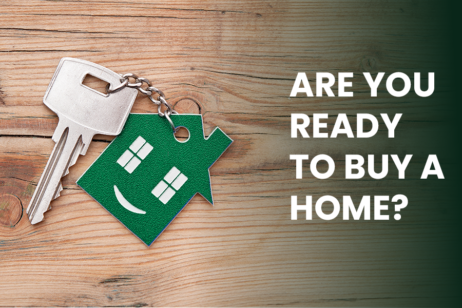House-shaped keychain with keys on a wooden surface beside text reading “Are you ready to buy a home?”